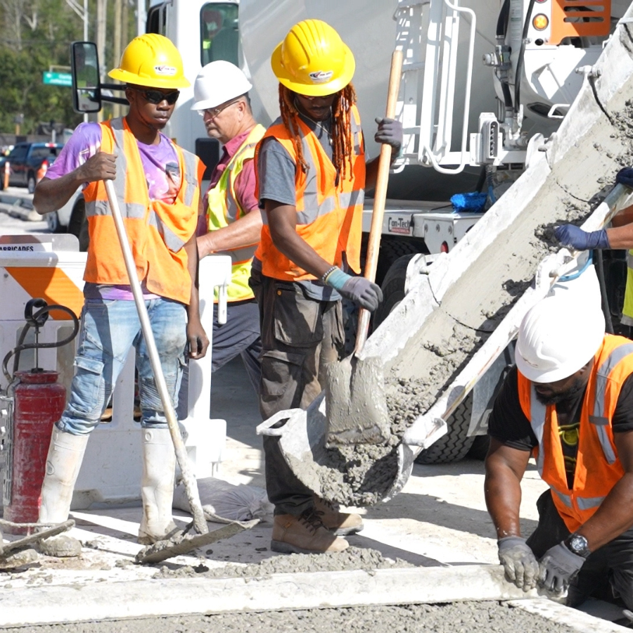 Construction crew pouring concrete from cement truck