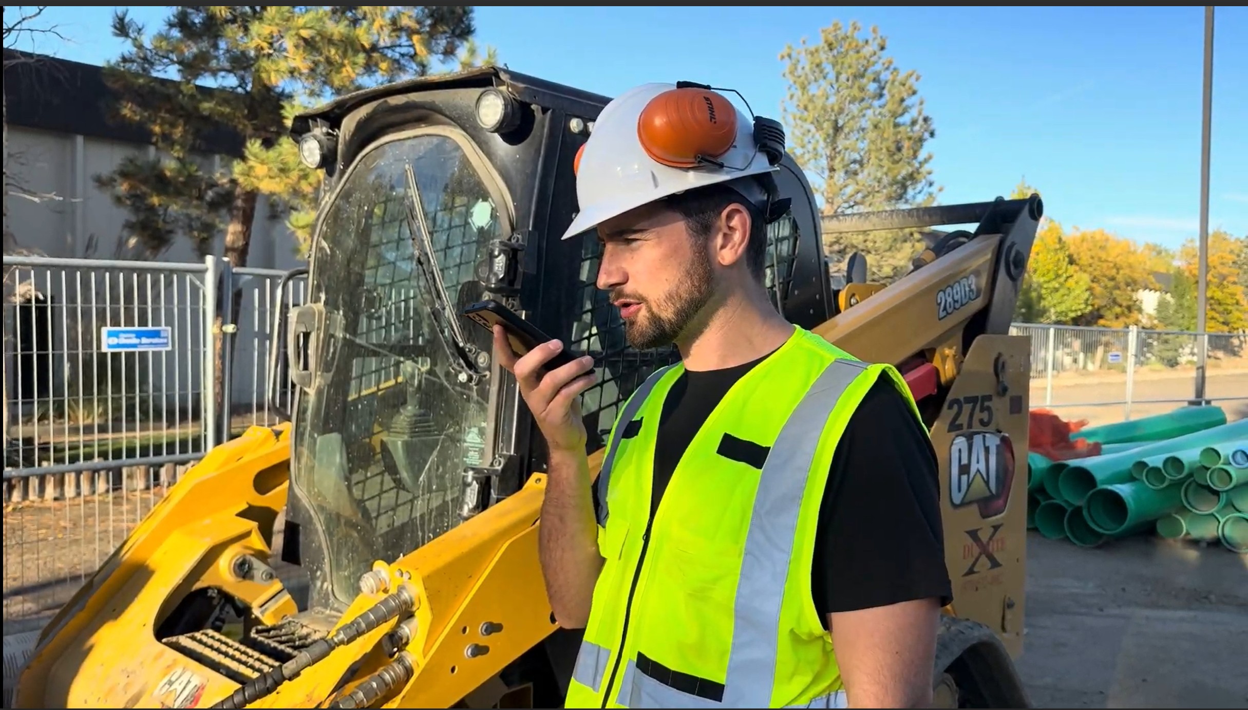 Construction worker using phone on jobsite